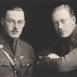 Two men sitting side by side, wearing war uniform