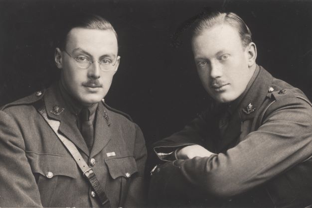 Two men sitting side by side, wearing war uniform