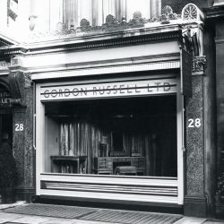 Exterior of store front. Gordon Russell Ltd sign above the window.