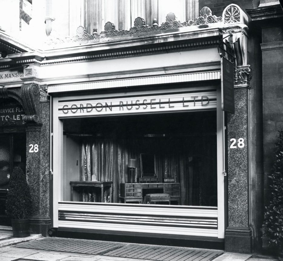 Exterior of store front. Gordon Russell Ltd sign above the window.
